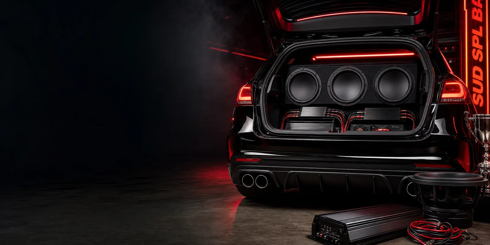 Droppin HZ Car Audio — high-power SPL car audio build featuring a glowing subwoofer and amplifier system